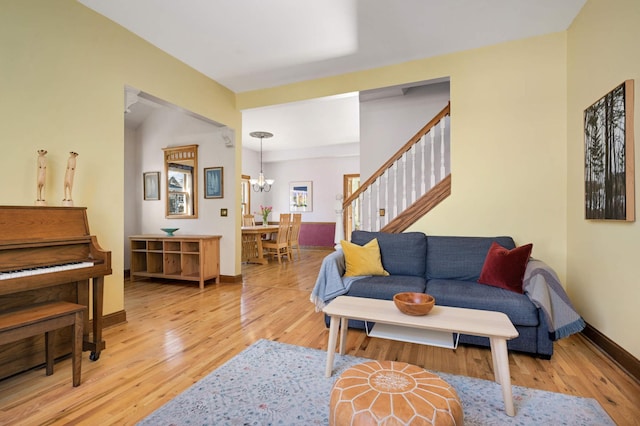 living room featuring a notable chandelier and light hardwood / wood-style flooring