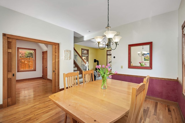 dining room featuring a notable chandelier and light hardwood / wood-style floors