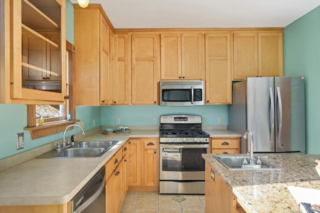 kitchen with stainless steel appliances, sink, and light tile patterned floors