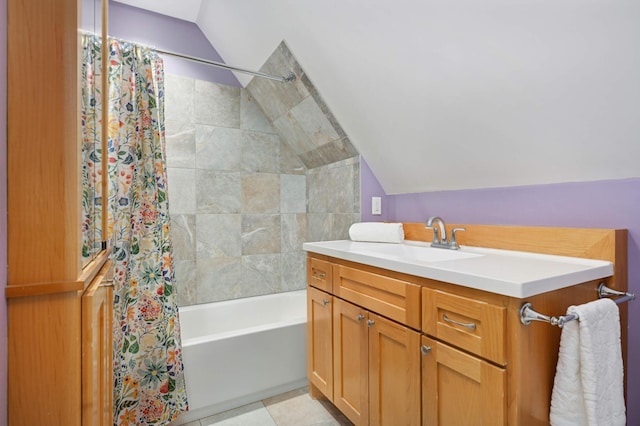 bathroom featuring lofted ceiling, vanity, tile patterned floors, and shower / bathtub combination with curtain