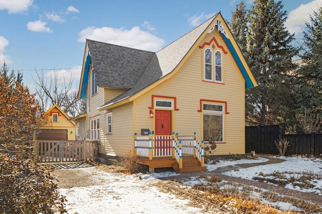 view of front facade featuring a garage and an outdoor structure