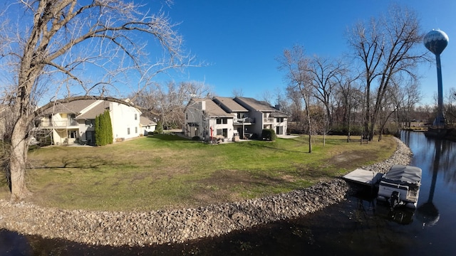 view of property exterior with a water view and a lawn