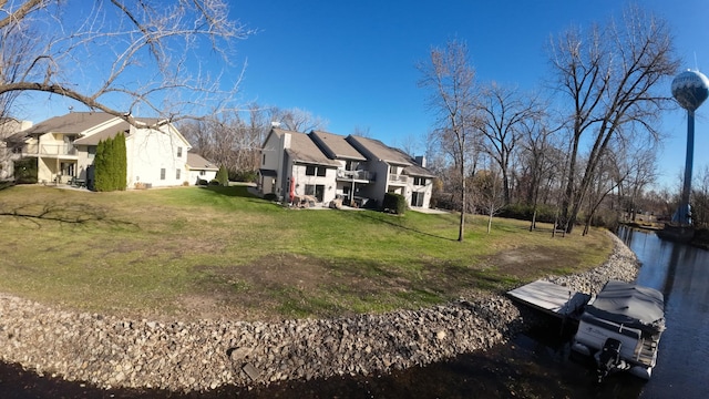 rear view of property featuring a yard and a water view