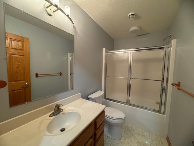 full bathroom with vanity, toilet, shower / bath combination with glass door, and a textured ceiling