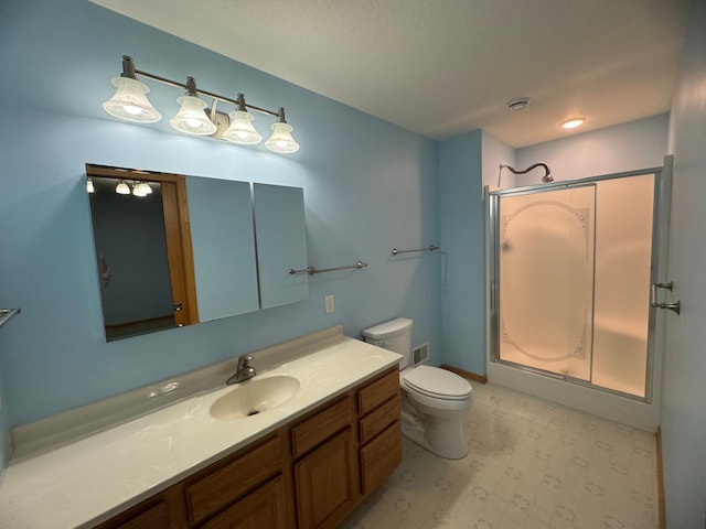 bathroom with a shower, vanity, and toilet