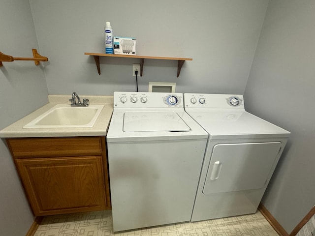 laundry area with sink, cabinets, and independent washer and dryer