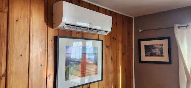 room details featuring wood walls and a wall unit AC