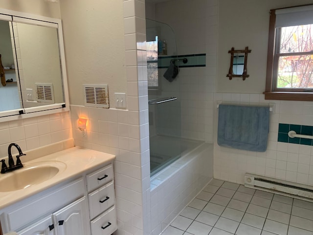 bathroom featuring tile patterned flooring, vanity, and a baseboard heating unit