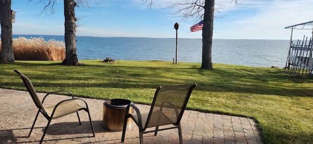 view of yard featuring a patio area and a water view