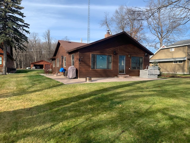 back of property featuring a lawn and a patio area