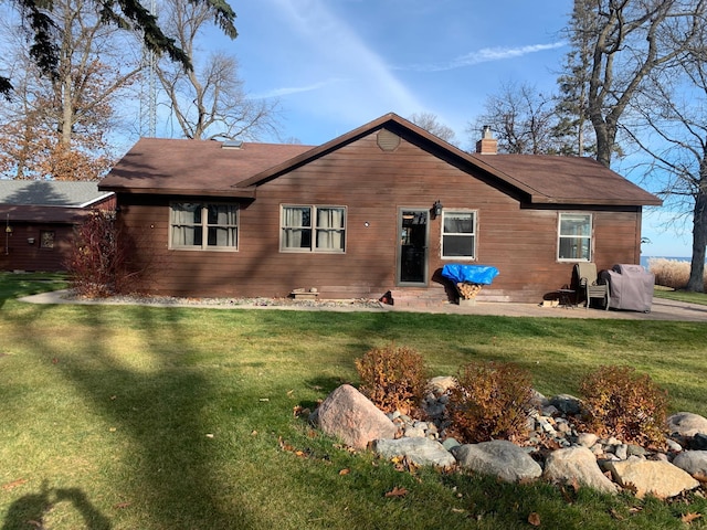 rear view of house with a yard