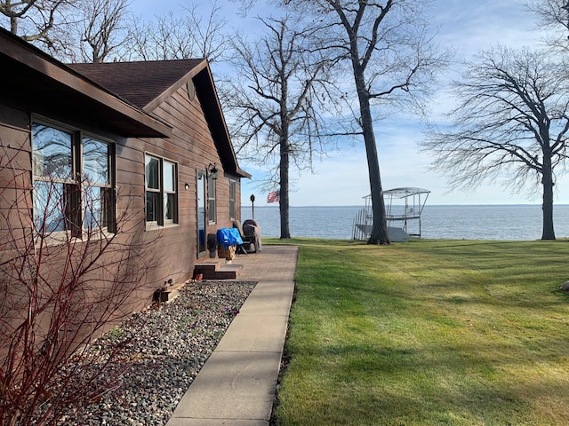 view of property exterior featuring a lawn and a water view