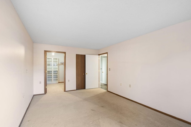 unfurnished room with light carpet