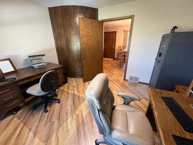 office featuring a textured ceiling and light hardwood / wood-style floors