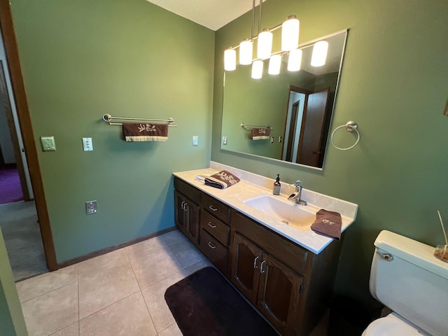 bathroom with tile patterned flooring, vanity, and toilet