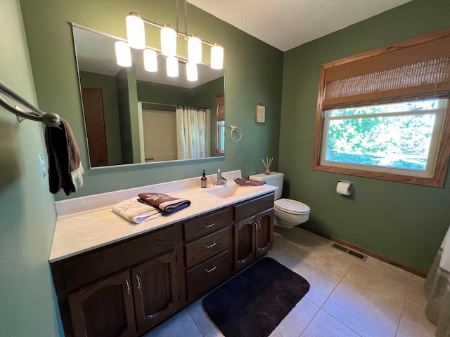 bathroom featuring tile patterned floors, curtained shower, vanity, and toilet