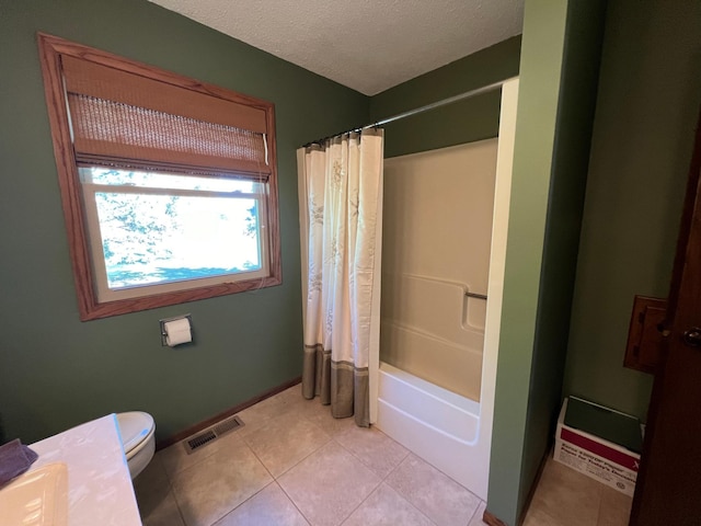 full bathroom with vanity, tile patterned floors, toilet, shower / bath combo with shower curtain, and a textured ceiling