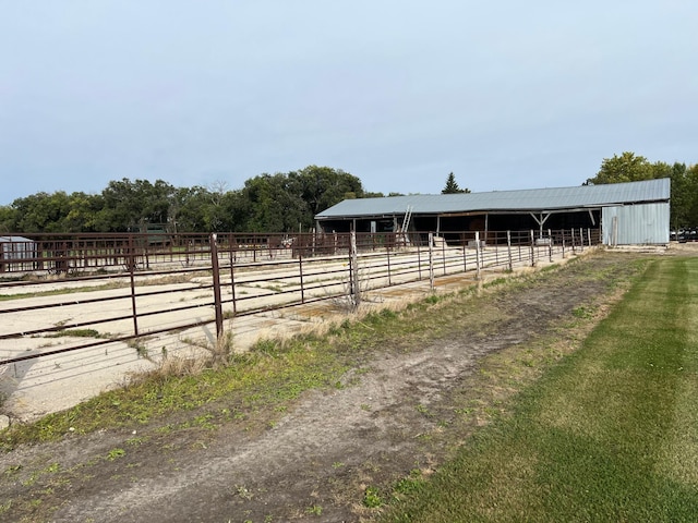 view of stable with a rural view