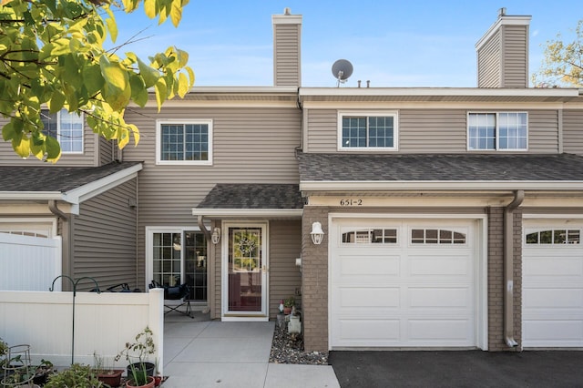 townhome / multi-family property featuring a garage