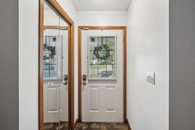 doorway featuring a textured ceiling