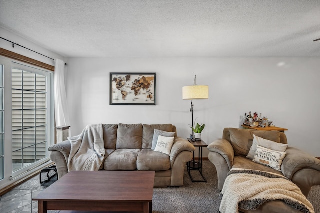 carpeted living room featuring a textured ceiling