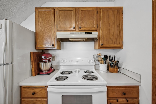 kitchen featuring a textured ceiling and white appliances