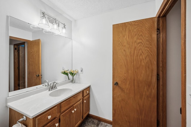 bathroom with vanity and a textured ceiling