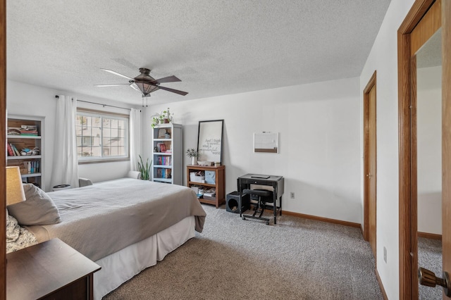 bedroom with a textured ceiling, ceiling fan, and carpet