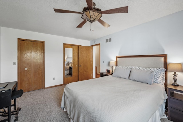 bedroom featuring ceiling fan, carpet, and a textured ceiling