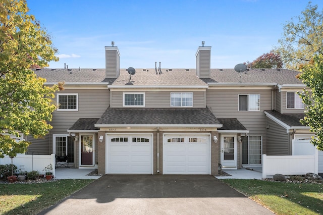 view of front of property with a garage and a front lawn