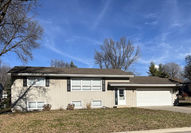 view of front of property with a front yard and a garage