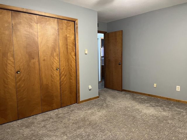 unfurnished bedroom featuring carpet and a closet