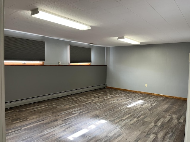 unfurnished room featuring a baseboard radiator and dark wood-type flooring