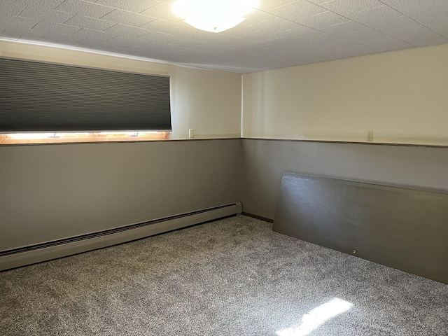 unfurnished room featuring carpet floors and baseboard heating