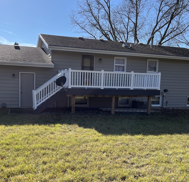 rear view of property with a yard and a wooden deck