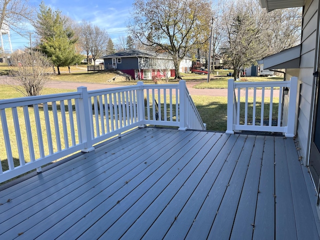 wooden deck featuring a yard