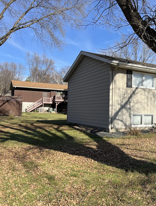 view of property exterior featuring a yard and a deck