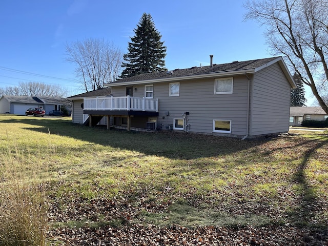 back of house with a lawn and a wooden deck