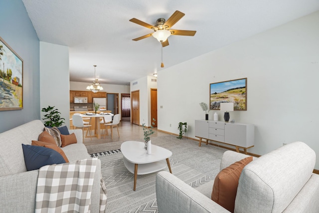 living area with ceiling fan with notable chandelier and baseboards