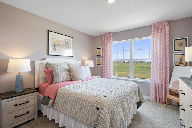 bedroom featuring a textured ceiling and carpet floors