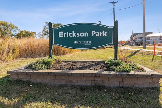 community / neighborhood sign with a lawn