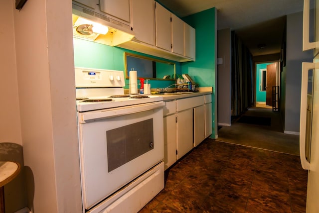 kitchen with white cabinetry, white range with electric cooktop, and sink