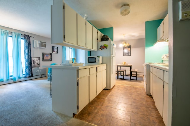 kitchen with light carpet, white appliances, a wall mounted AC, decorative light fixtures, and white cabinetry