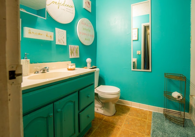 bathroom featuring vanity, toilet, and a textured ceiling