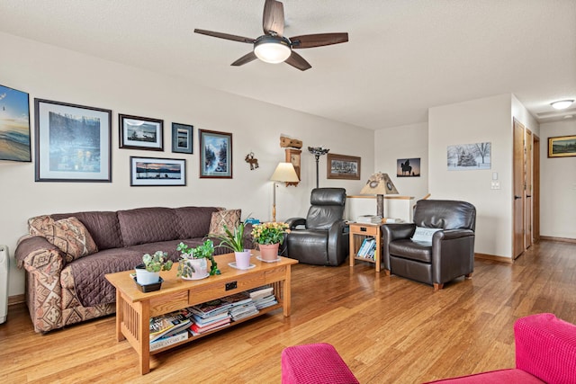 6972 360th St, North Branch, MN 55056 - living area with a ceiling fan, light wood-style floors, and baseboards