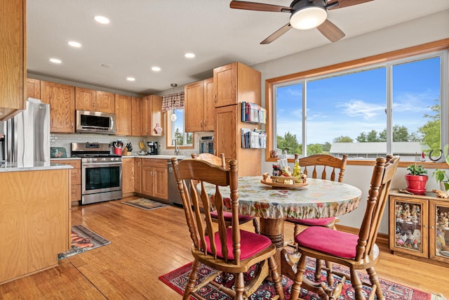 6972 360th St, North Branch, MN 55056 - kitchen with appliances with stainless steel finishes, recessed lighting, a sink, light wood-style floors, and a ceiling fan