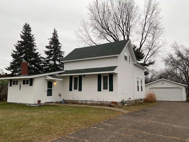 view of front of property with an outbuilding, a garage, and a front yard