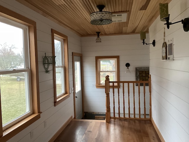 doorway featuring wood-type flooring, a wealth of natural light, and wood ceiling