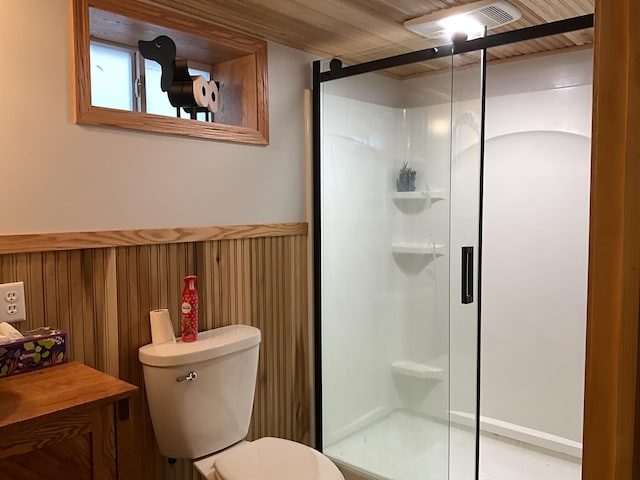 bathroom featuring wood walls, an enclosed shower, and toilet