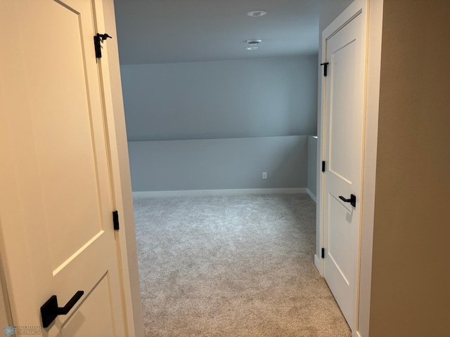 unfurnished room featuring light carpet